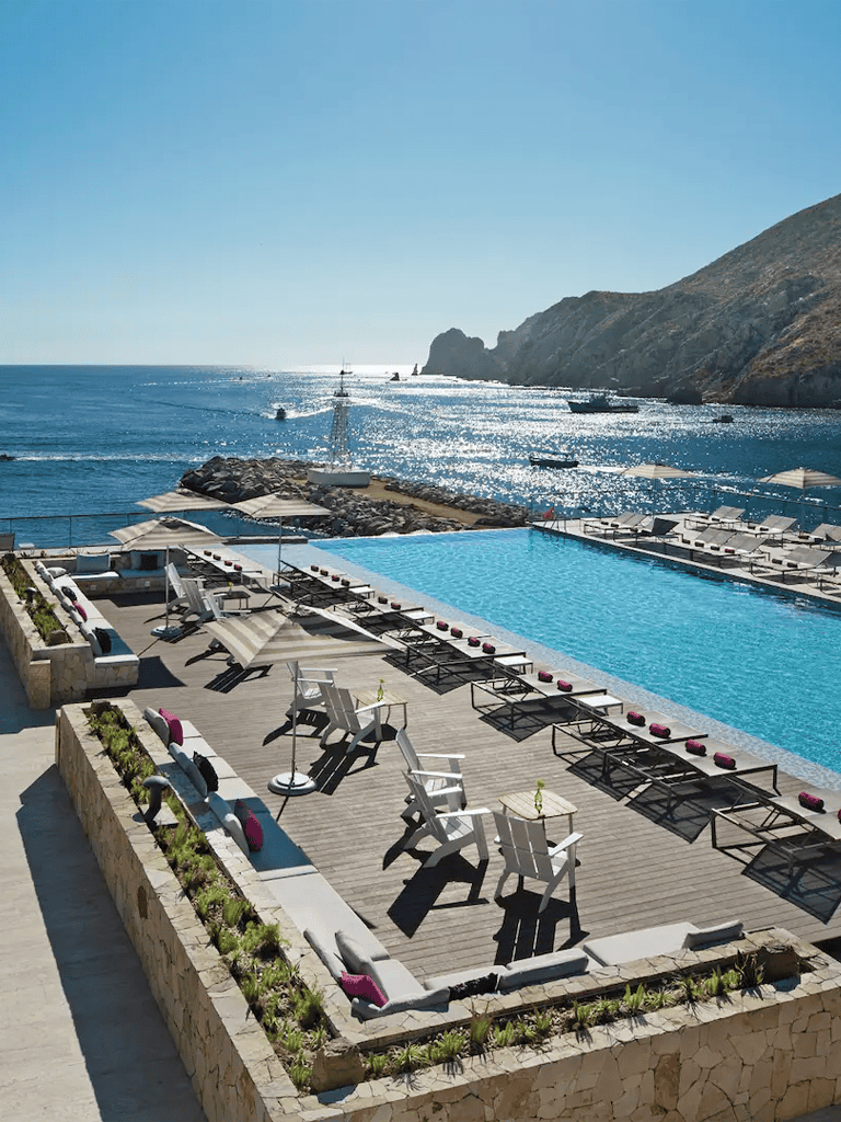 Stunning ocean view from luxurious poolside lounge area at Quest For Directions, coastal retreat.