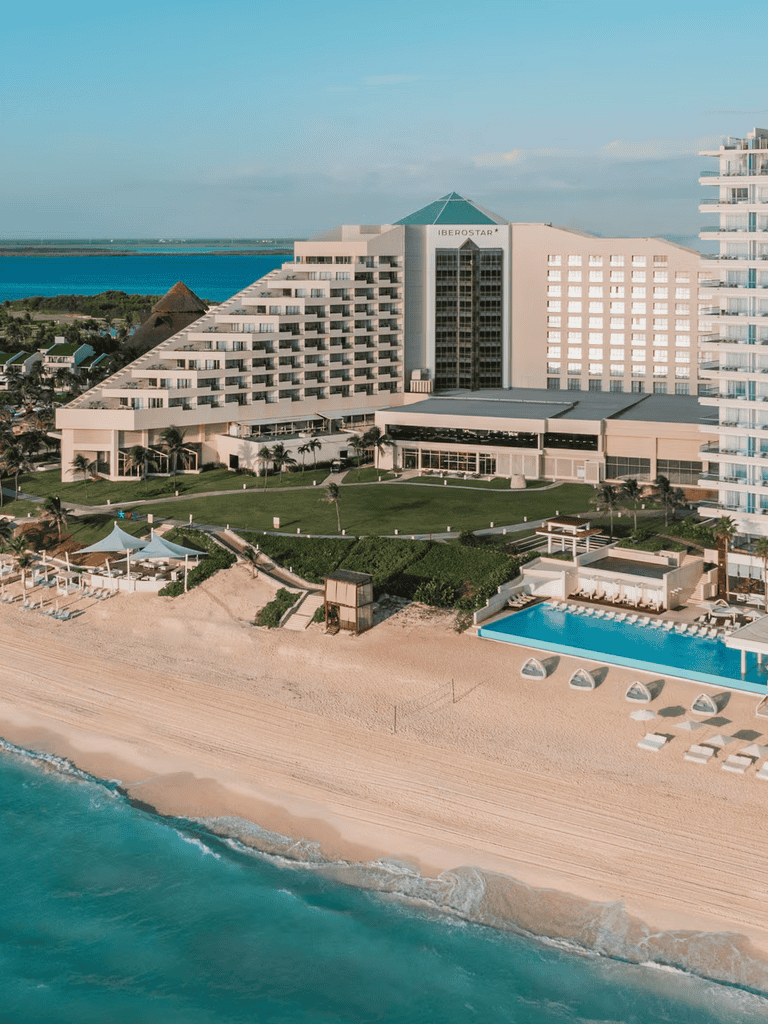 Luxurious beachfront hotel with ocean view and pool, ideal for vacation rentals.