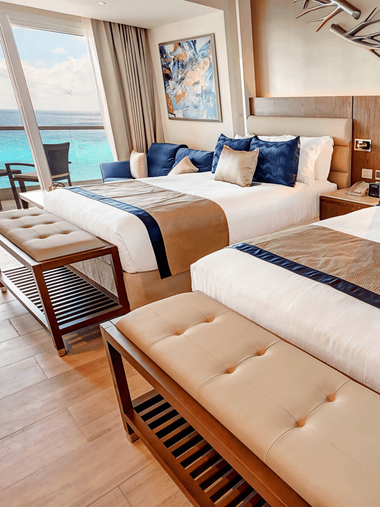 Luxurious ocean-view hotel room with modern decor and comfortable bedding.