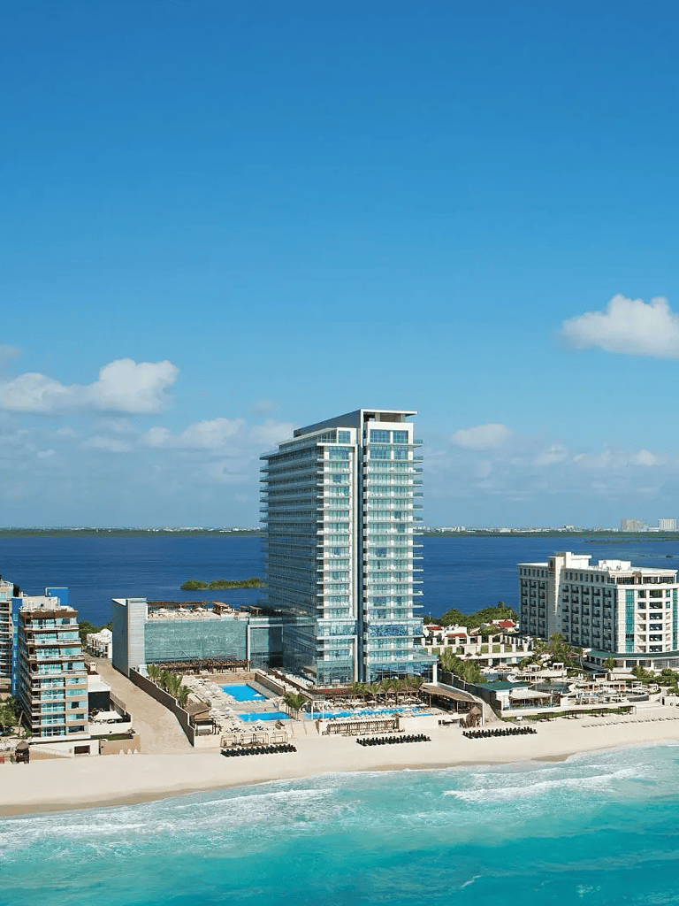 Luxury beachfront hotel with ocean views and swimming pools in a tropical destination.