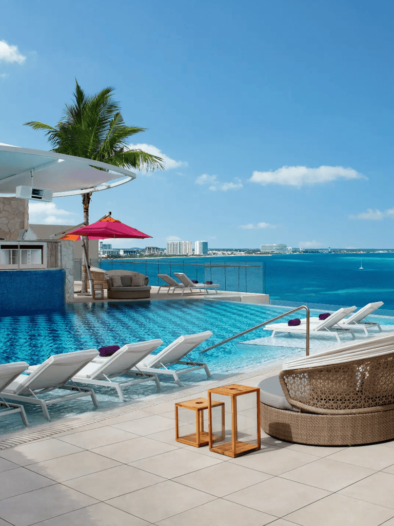 Luxurious ocean view poolside at a tropical resort, perfect for relaxation and vacation.
