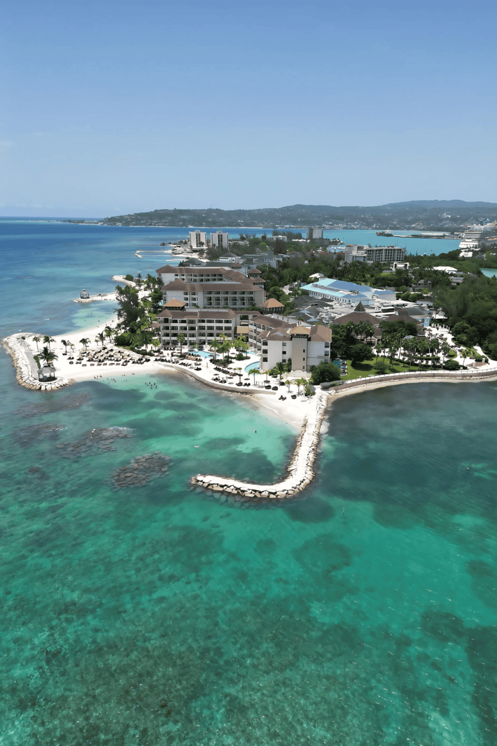 Luxurious beachfront resort on a tropical island with crystal-clear waters and stunning ocean views.