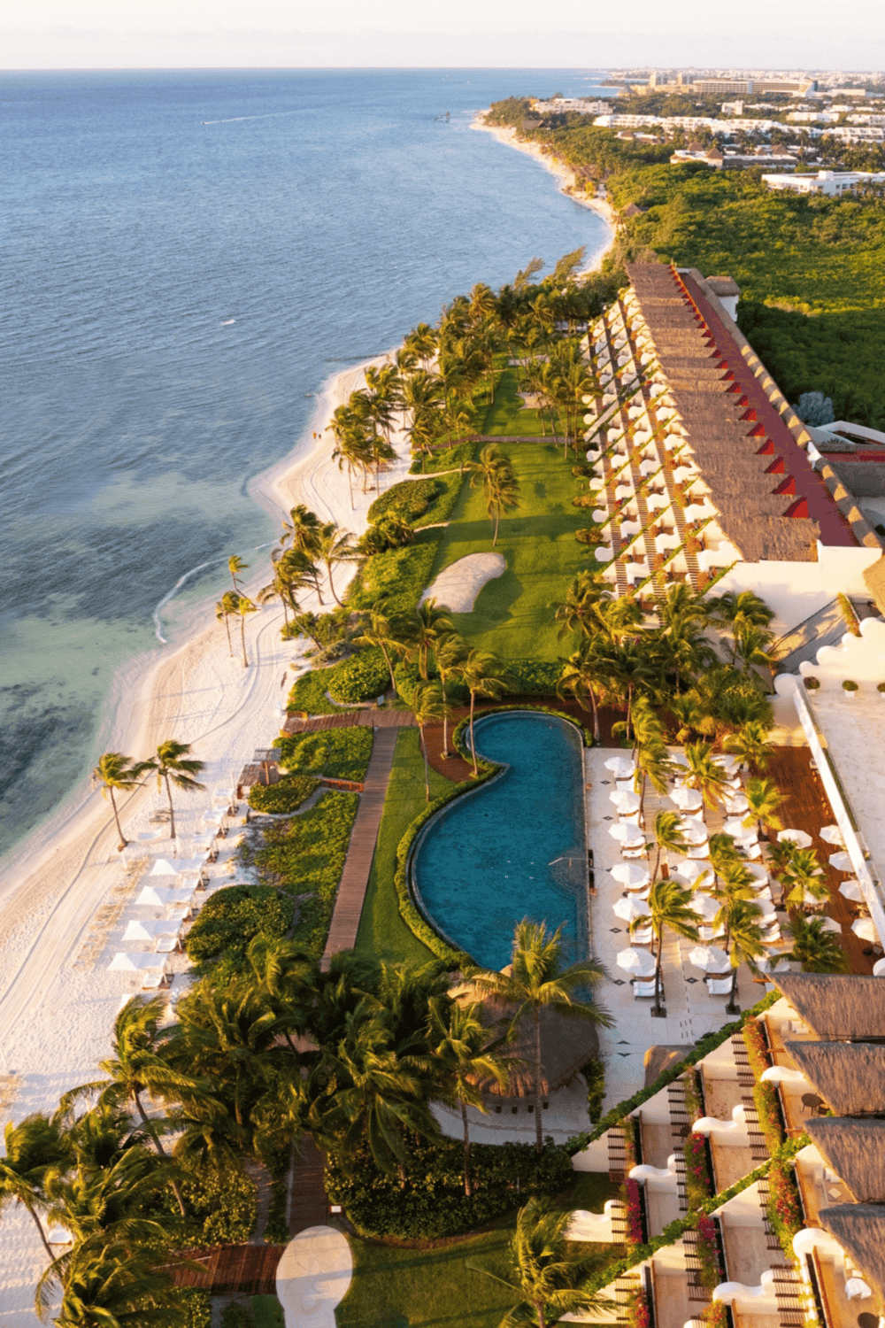 Luxurious beach resort with ocean views and tropical landscaping, perfect for a relaxing vacation.