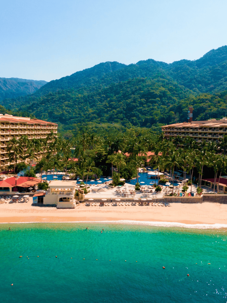 Luxurious beach resort with tropical landscape and ocean view.
