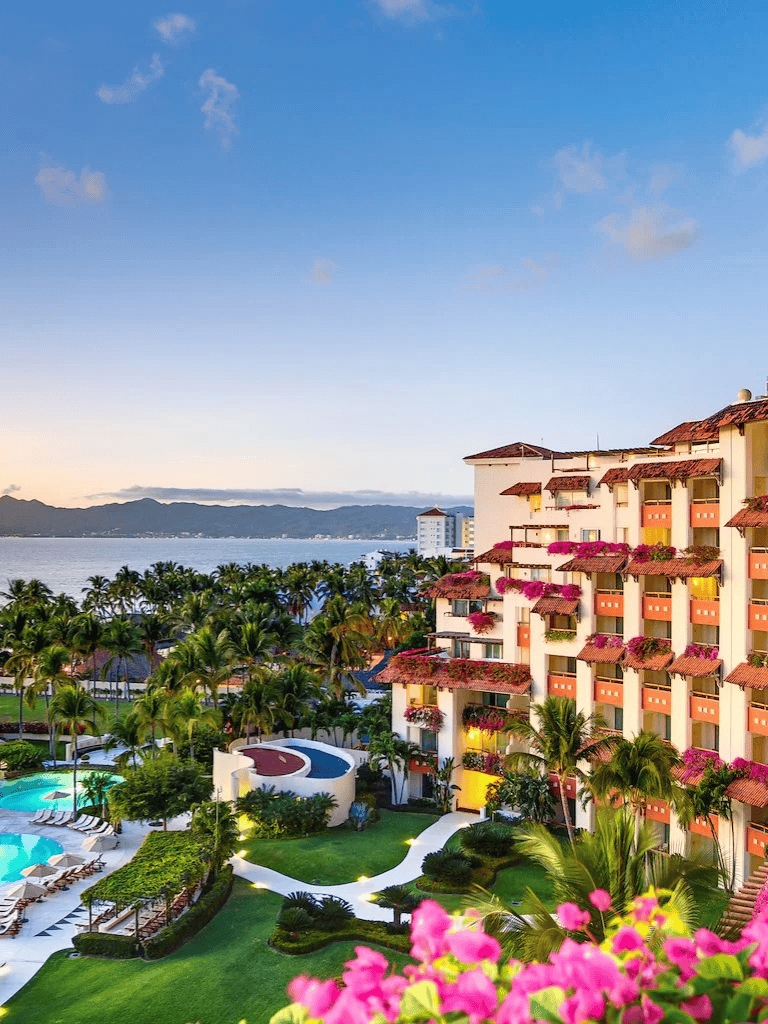 Luxurious beachfront hotel with ocean views and tropical gardens, perfect for relaxing vacations.