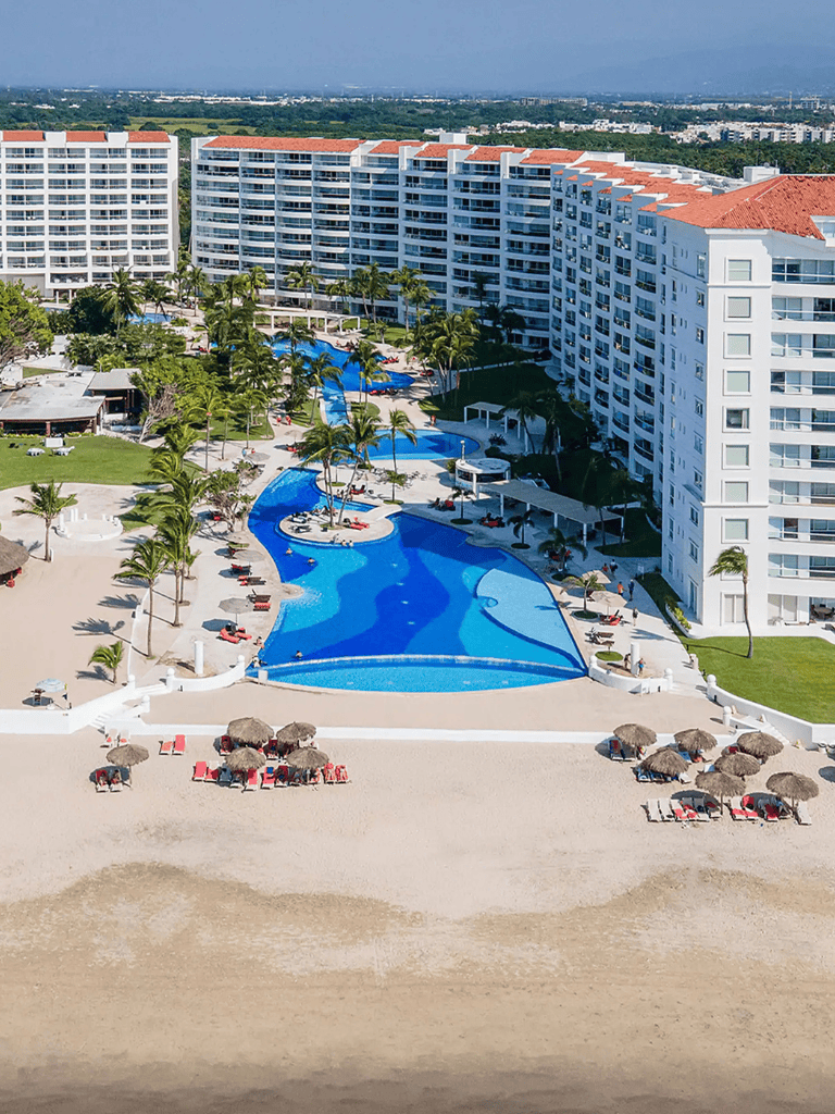 Luxury beachfront resort with pool and ocean views.