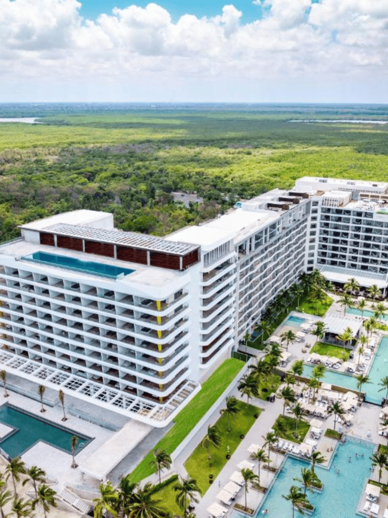 Luxurious beachfront hotel with infinity pool and tropical gardens, perfect for relaxation and leisure.