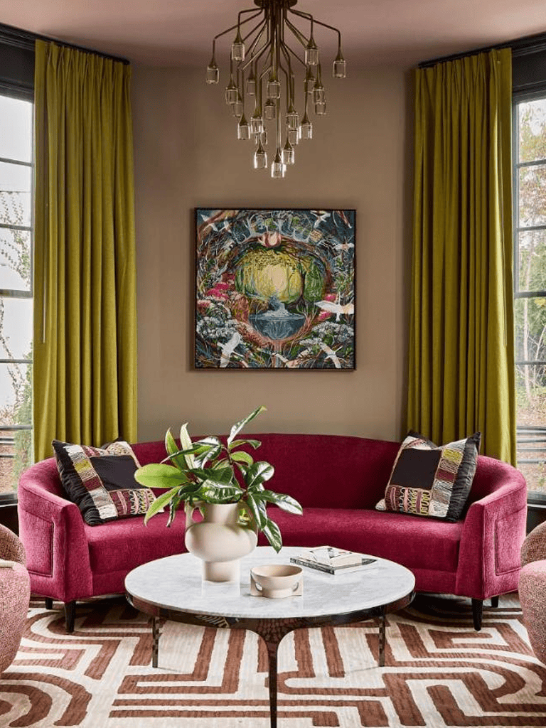 Elegant living room with colorful decor, lush greenery, and contemporary art, perfect for stylish home interior inspiration.