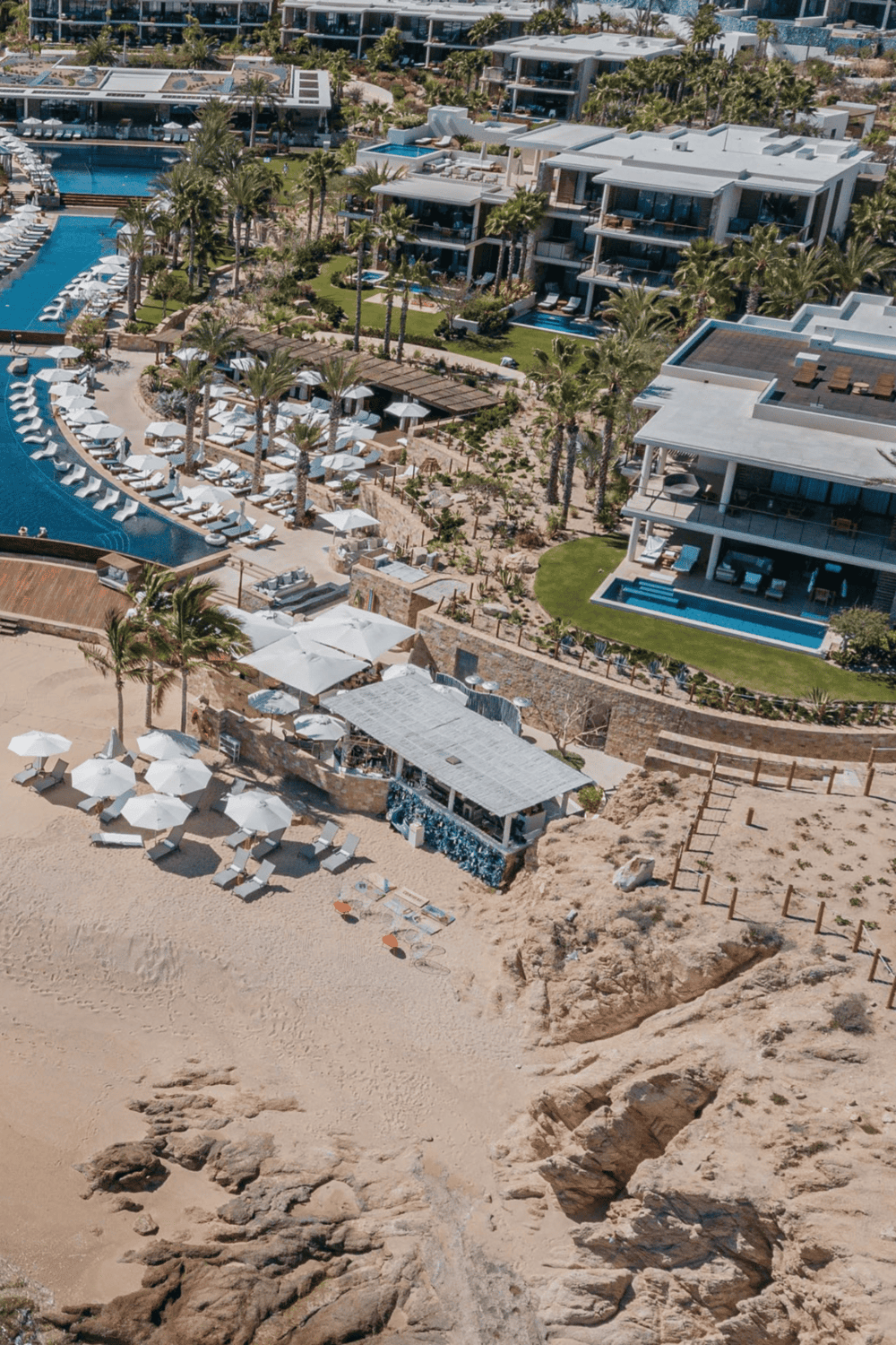 Luxury beachfront resort with infinity pools and modern villas.