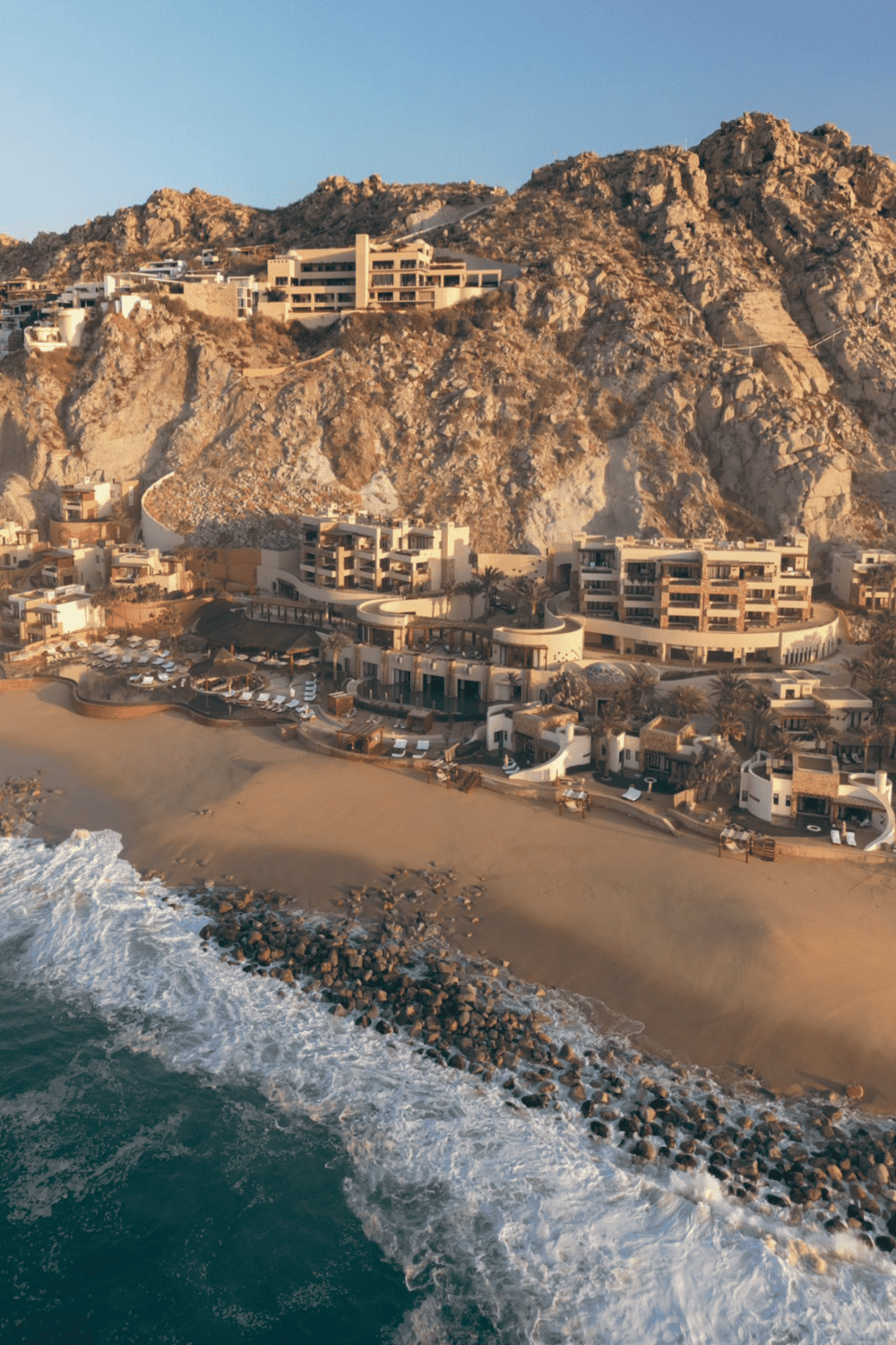 Clifftop luxury resort overlooking the ocean with modern architecture and beach access.