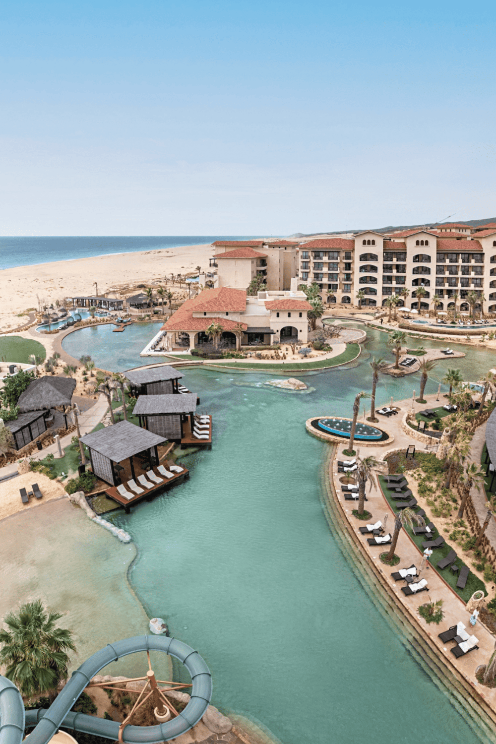 Luxurious beachfront resort with swimming pools, water slides, and scenic ocean views.
