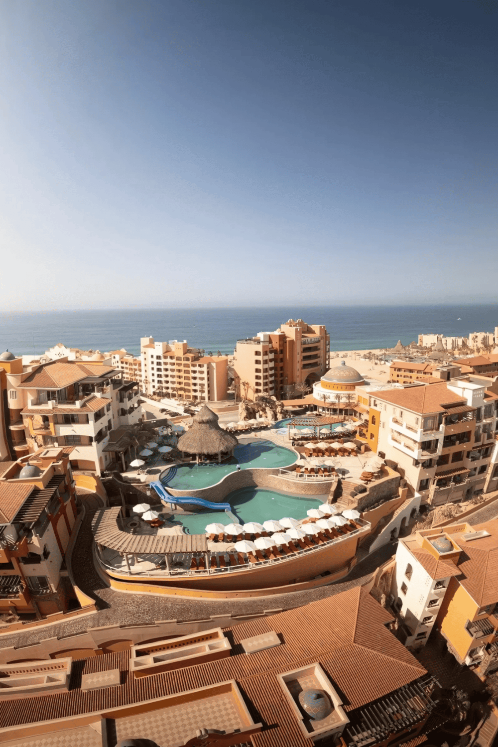 Stunning ocean view of luxury resort with pools and beach access in Mexico.