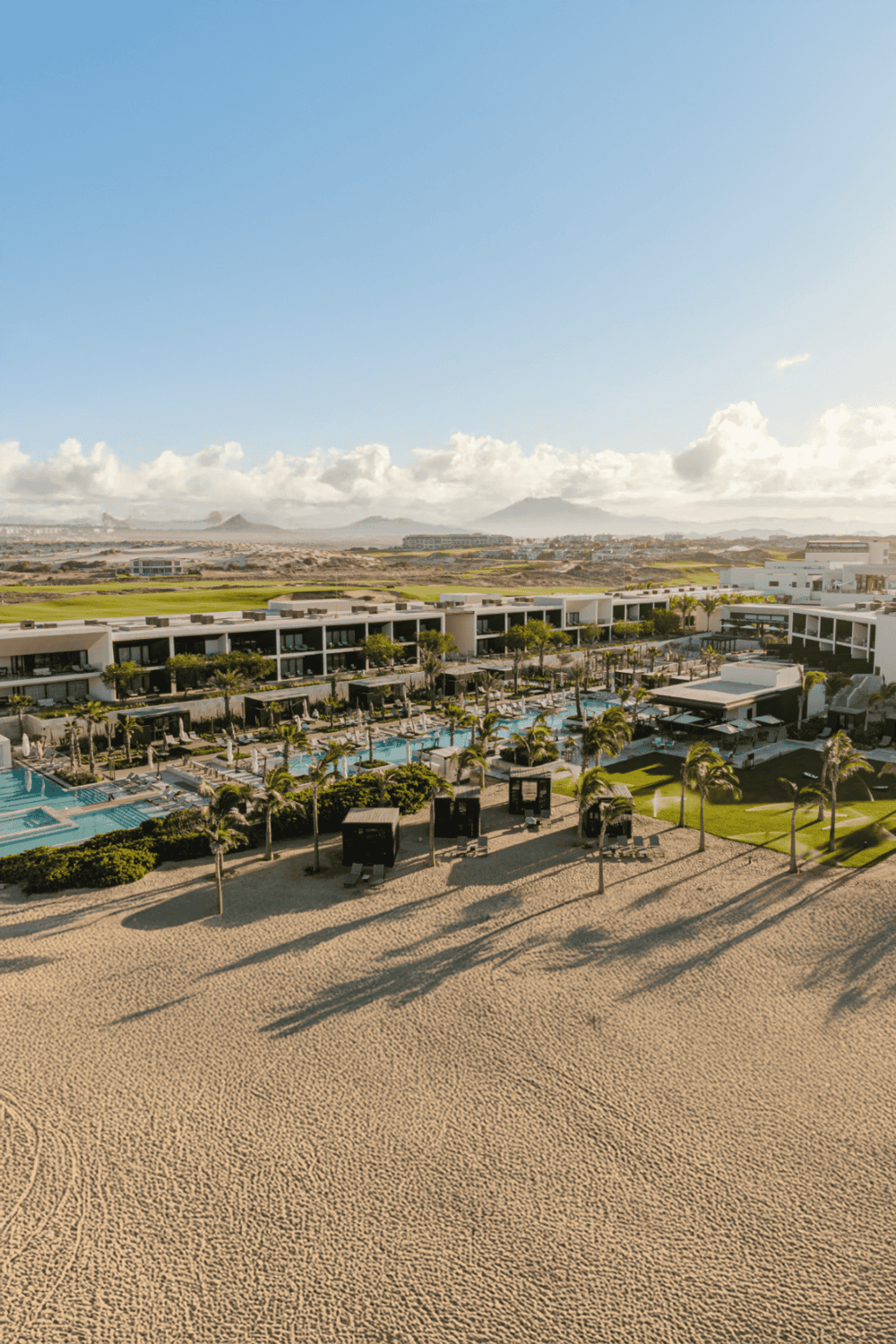 Luxurious beach resort with pools, palm trees, and ocean views at QuestForDirections.