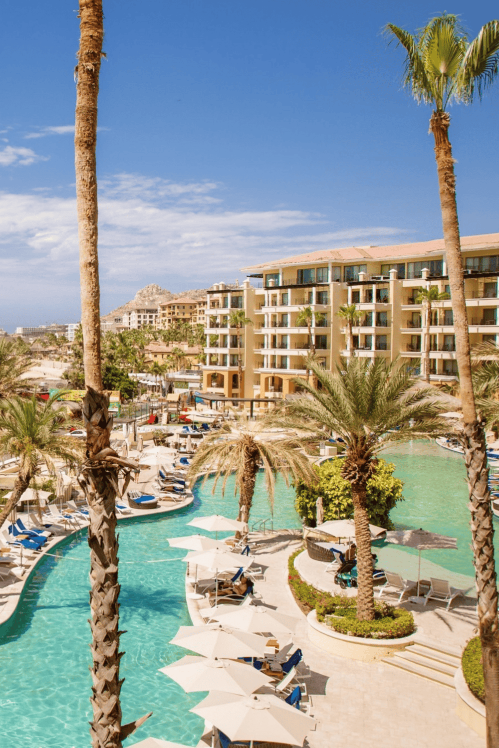 Luxurious resort pool with palm trees and mountain view, perfect for relaxation and vacation in Phoenix, Arizona.