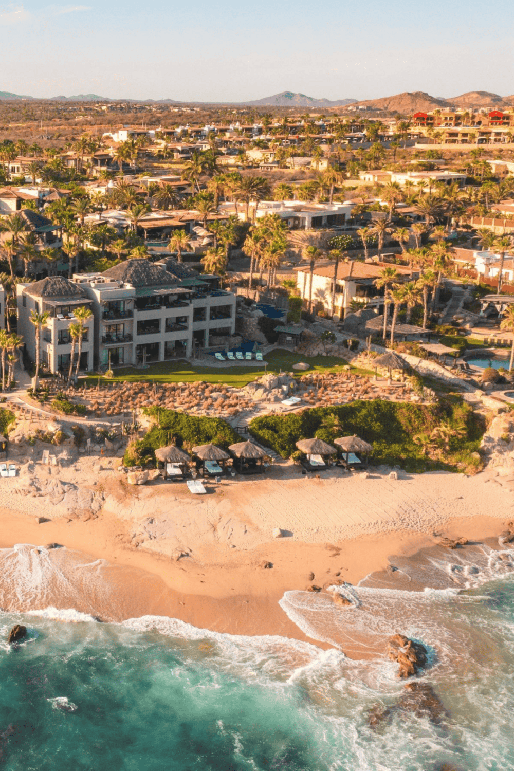 Luxury beachfront resort with palm trees and ocean views in a tropical destination.