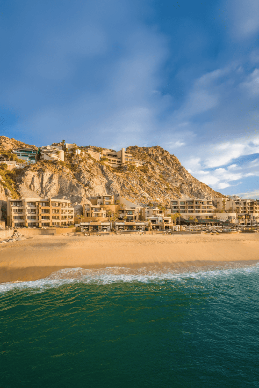 Beachside luxury resort overlooking the ocean and mountain scenery, perfect for vacations and travel.