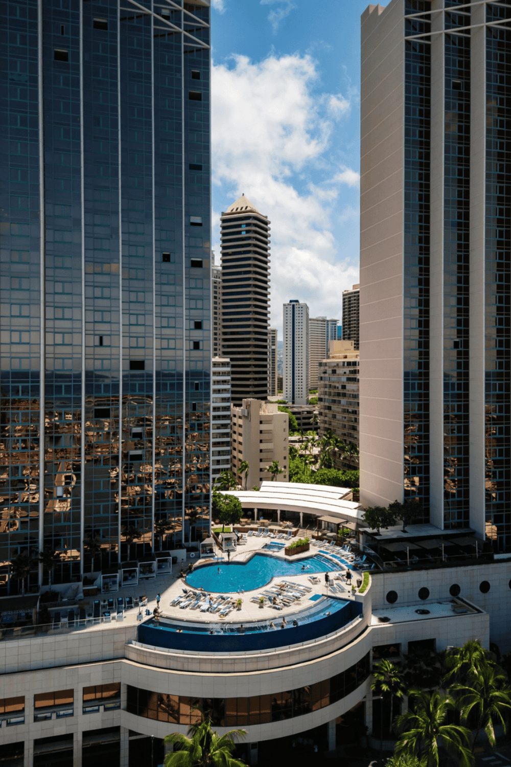 Mall rooftop pool with city skyline in the background.
