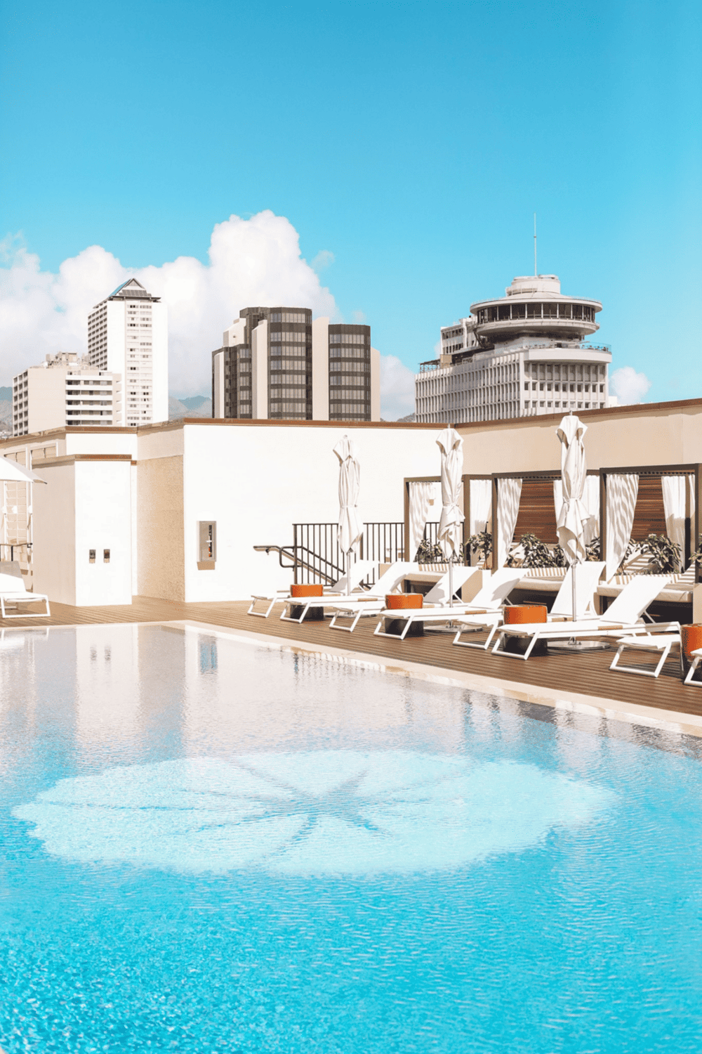 Luxury rooftop pool with city skyline view in downtown.