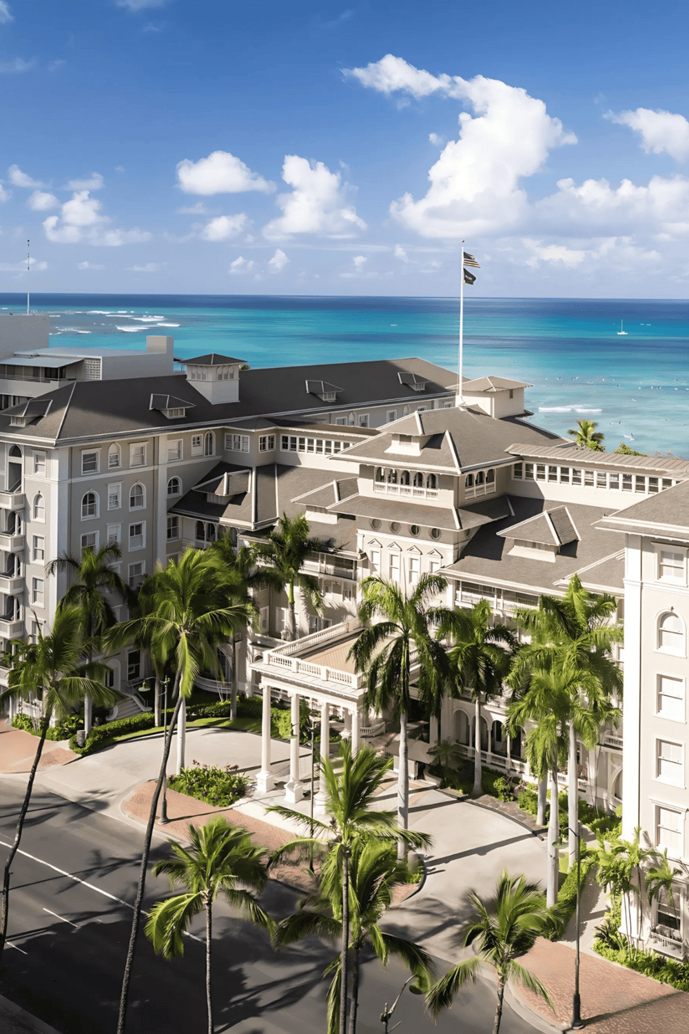 Luxury oceanfront hotel with palm trees and stunning sea views in Miami Beach.