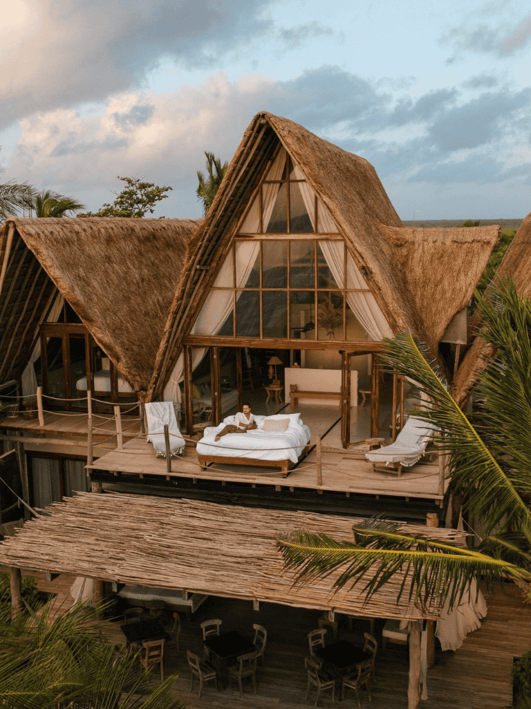 Luxurious bamboo and thatch-roof eco-resort with modern amenities and scenic views.