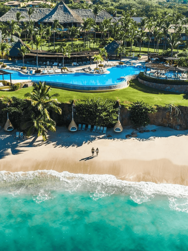 Luxurious beachfront resort with infinity pool and tropical surroundings.