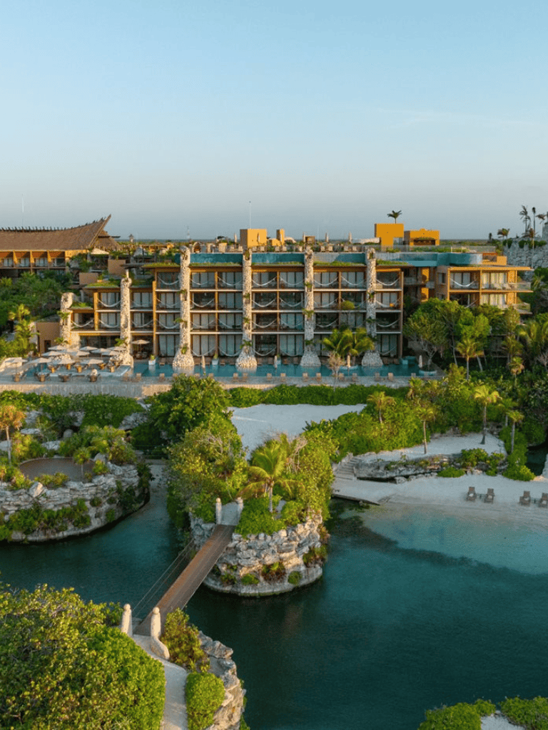 Luxurious beachfront resort with lush tropical landscaping and scenic water features.