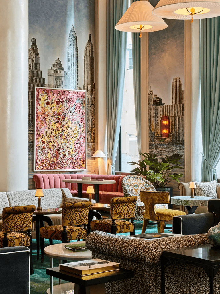 Luxurious hotel lounge with elegant furniture and city skyline mural, perfect for relaxing or socializing.