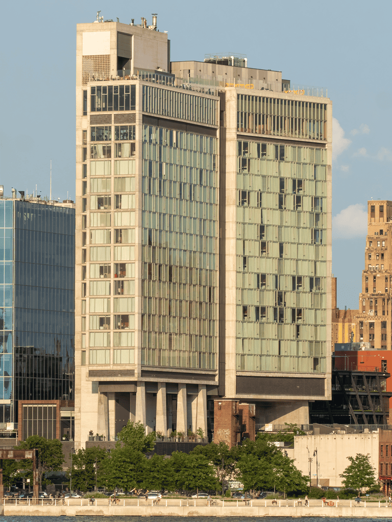 Modern city skyscraper with glass windows and urban surroundings.