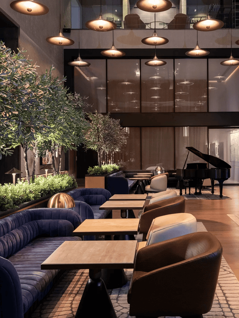 Modern hotel lobby with elegant seating and grand piano, perfect for relaxing or socializing.