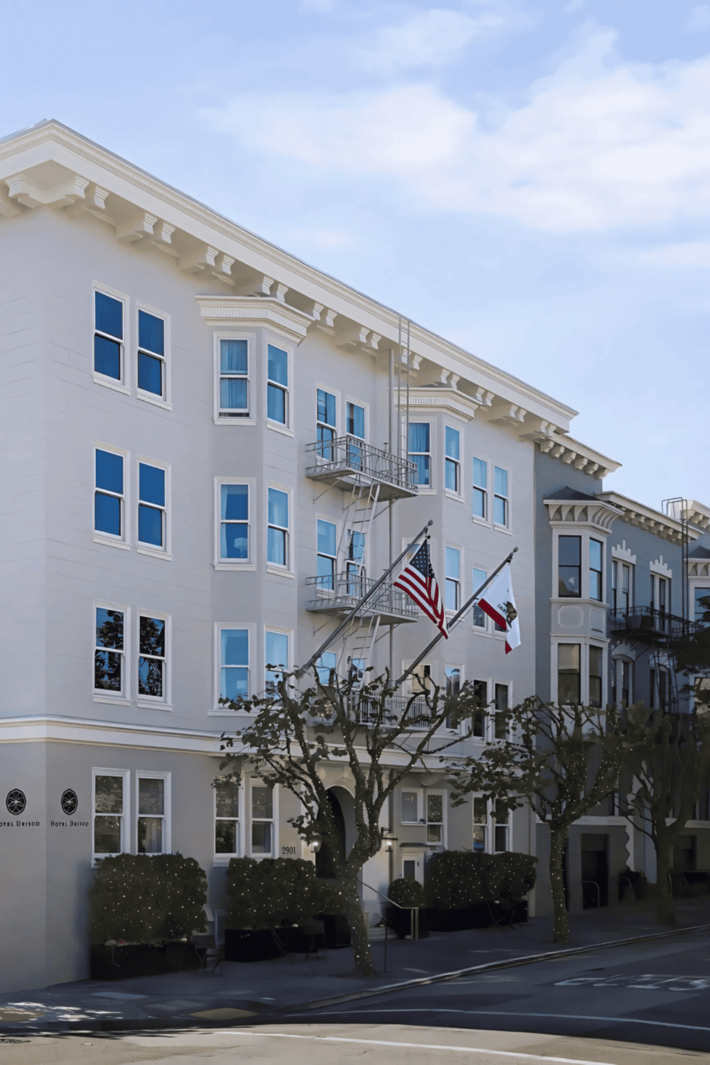 Historic San Francisco building with classic architecture and American flags, ideal for travel and hotel search SEO.