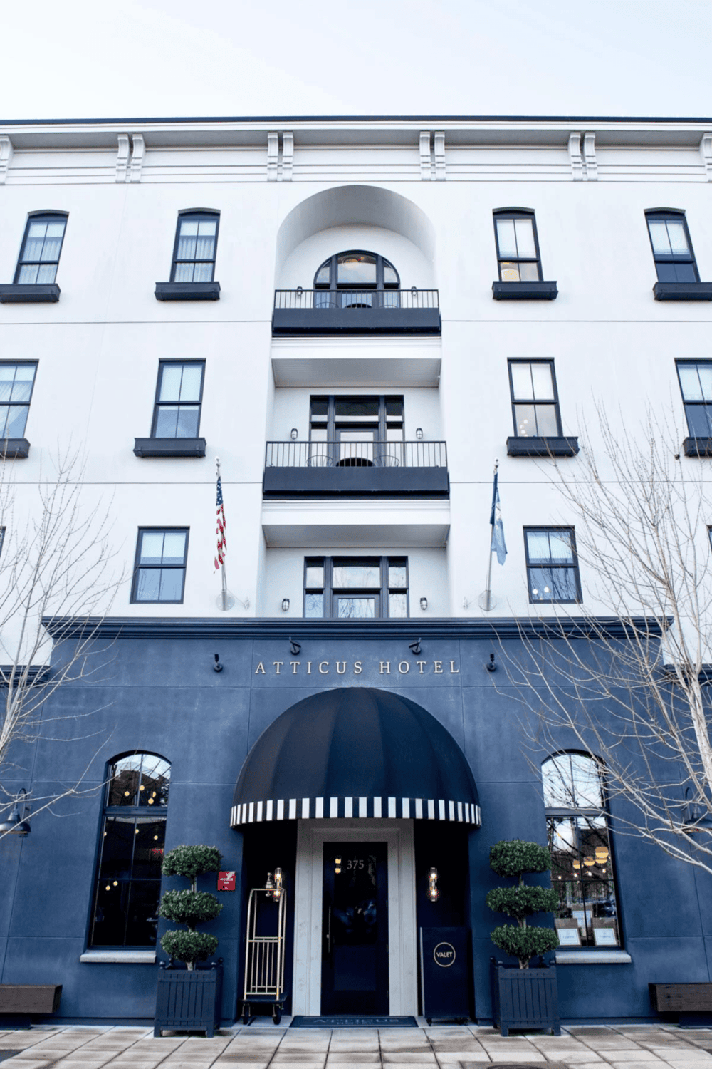 Atticus Hotel exterior with modern architecture and elegant entrance, ideal for guests seeking boutique accommodations.
