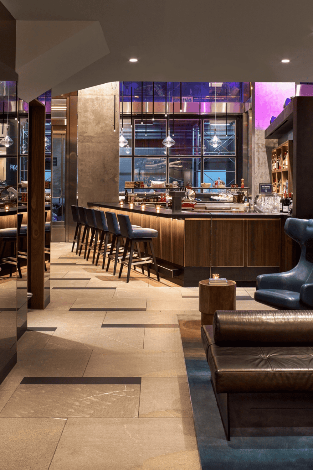 Modern bar interior with stylish seating and ambient lighting, ideal for socializing and dining.