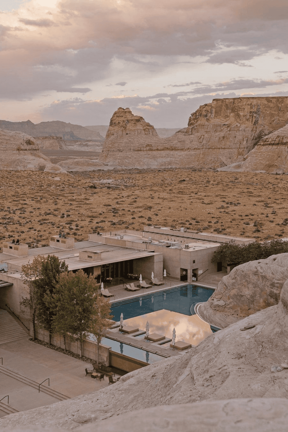 Serene desert resort with pool and mountain views in a remote canyon setting.