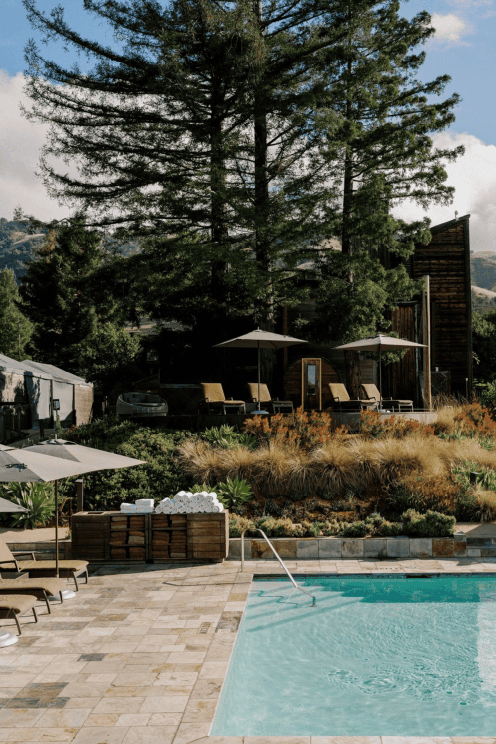 Luxurious outdoor swimming pool with scenic mountain views and relaxing lounge area.