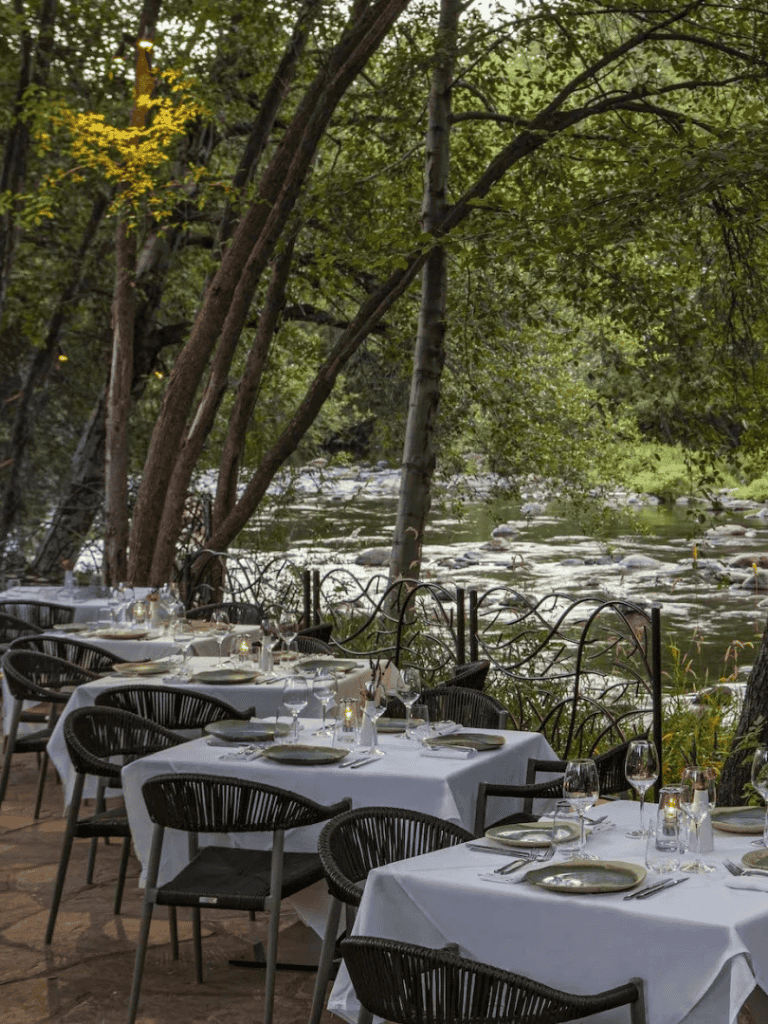 Relaxing outdoor riverside dining with elegant table setup at QuestForDirections.