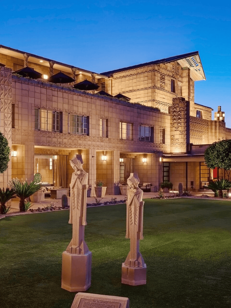 Elegant hotel exterior with modern architecture and art sculptures, perfect for luxury travel and accommodation.