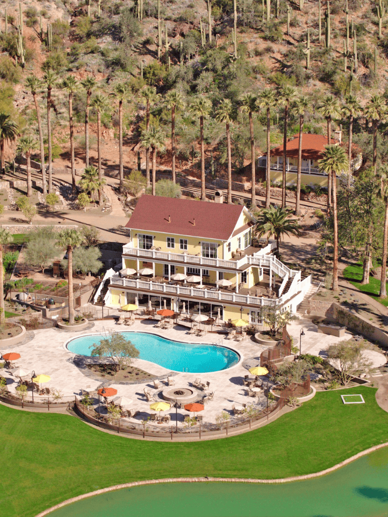 Relaxing desert resort with pool, palm trees, and mountain views for a perfect vacation.