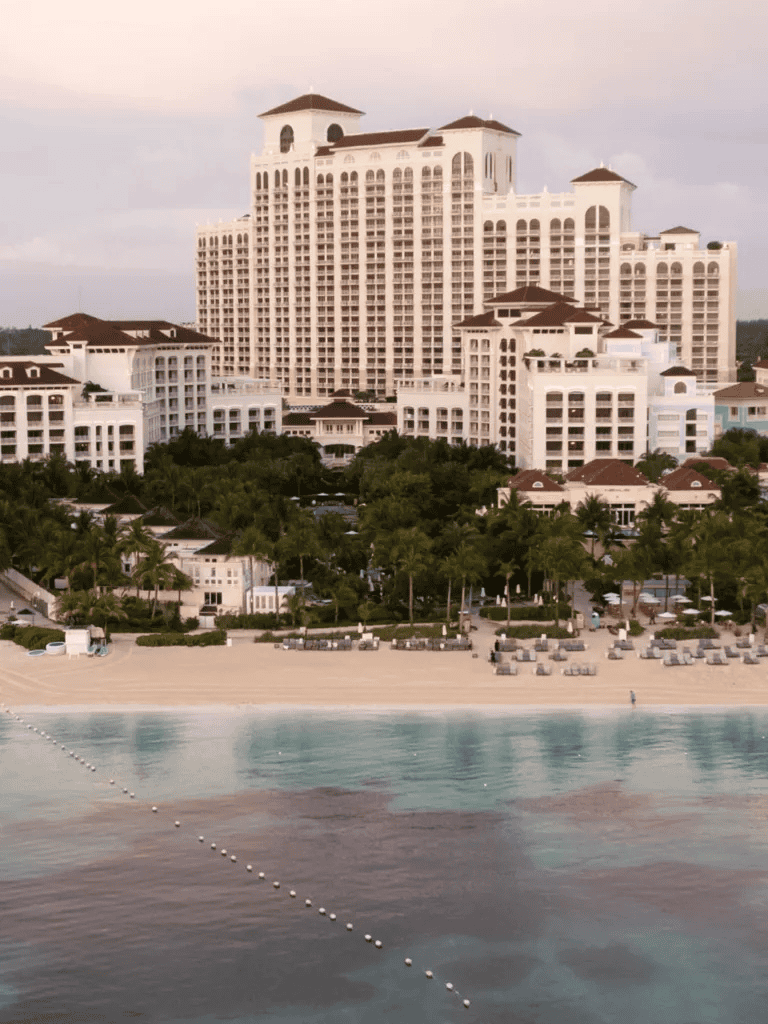 Luxurious beachfront hotel in a tropical setting with ocean views and landscaped gardens.