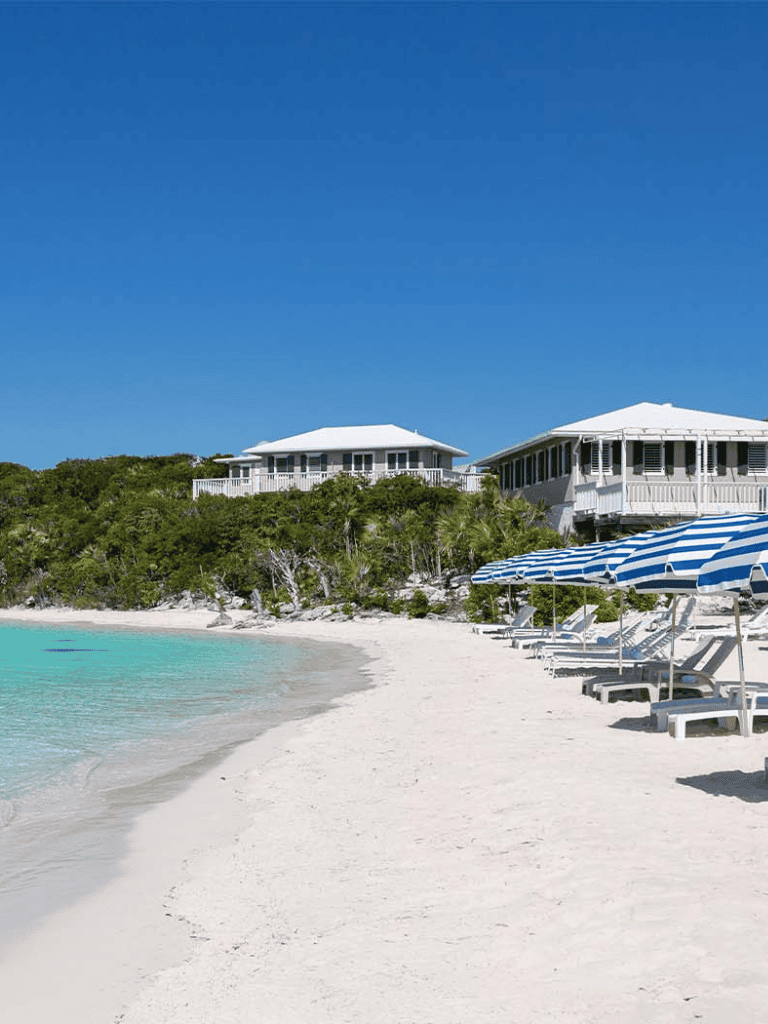 Beachfront resort with white sands, blue umbrellas, and luxurious villas at Quest for Directions.