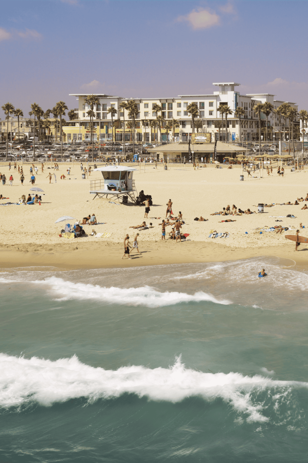 Beachside resort with beachfront hotel, sandy shores, and ocean waves, perfect for family vacations and water activities.