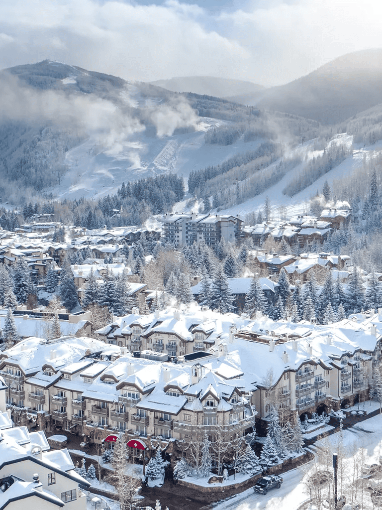Snow-covered mountain town with ski slopes and cozy buildings in winter.