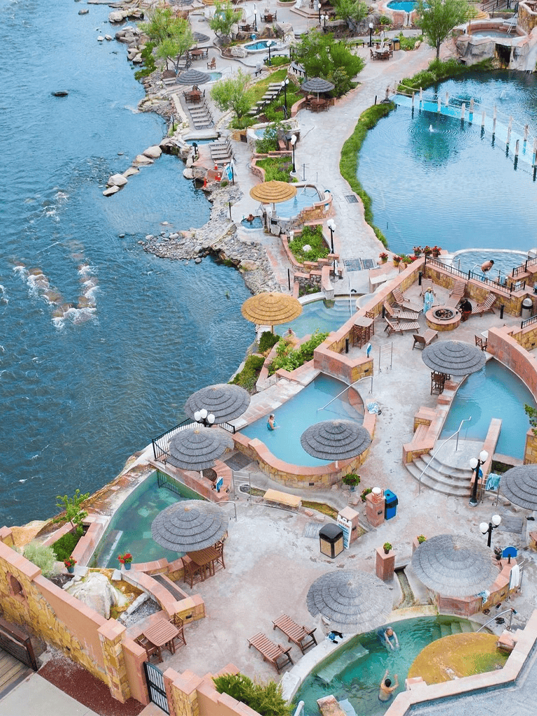 Outdoor hot tubs and pools with scenic water views at Quest for Directions resort.