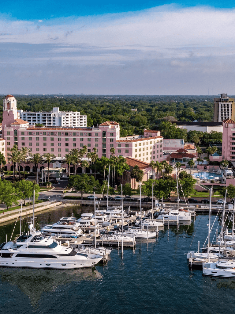Luxury marina with yachts and scenic city overview, perfect for waterfront travel and boating enthusiasts.