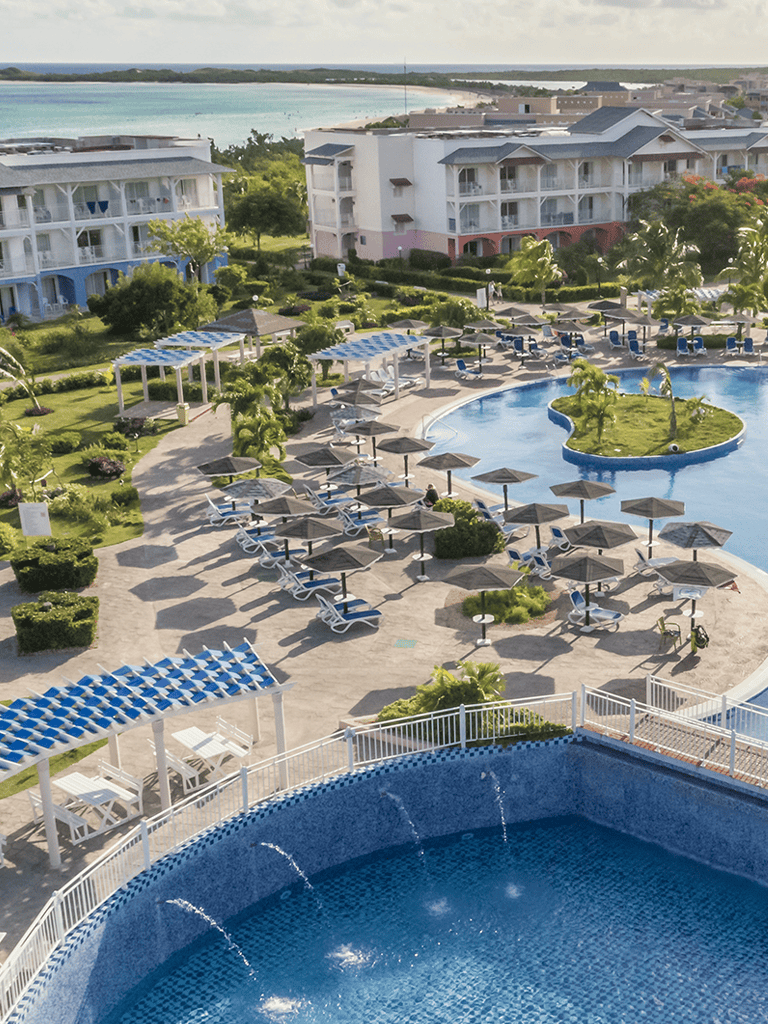 Beachfront resort pool and lounge area at QuestForDirections, featuring stunning ocean views and relaxing amenities.
