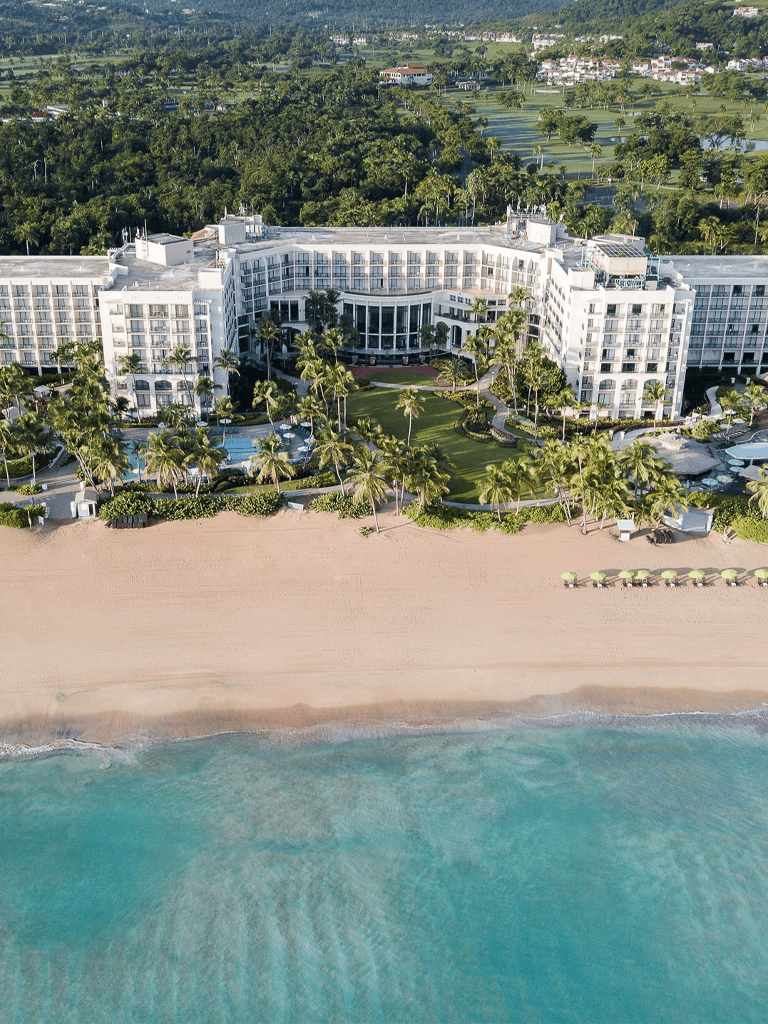 Luxury beachfront resort with ocean views and lush tropical gardens.
