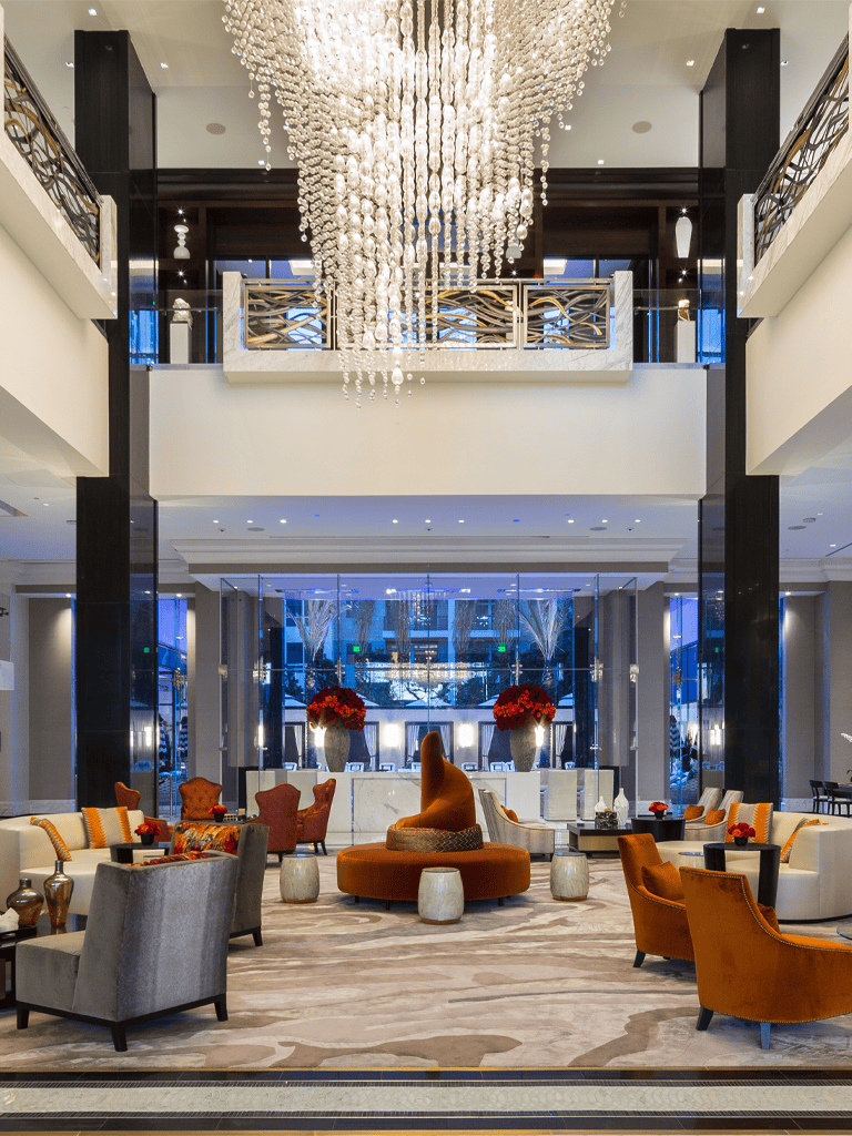 Luxurious hotel lobby with elegant chandeliers, modern decor, and stylish seating areas, perfect for upscale hospitality experiences.