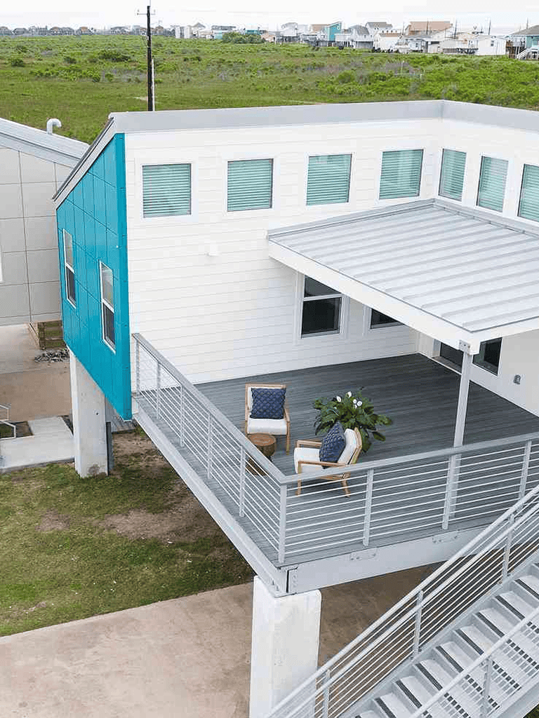 Contemporary house with spacious balcony, modern exterior design, and coastal view.