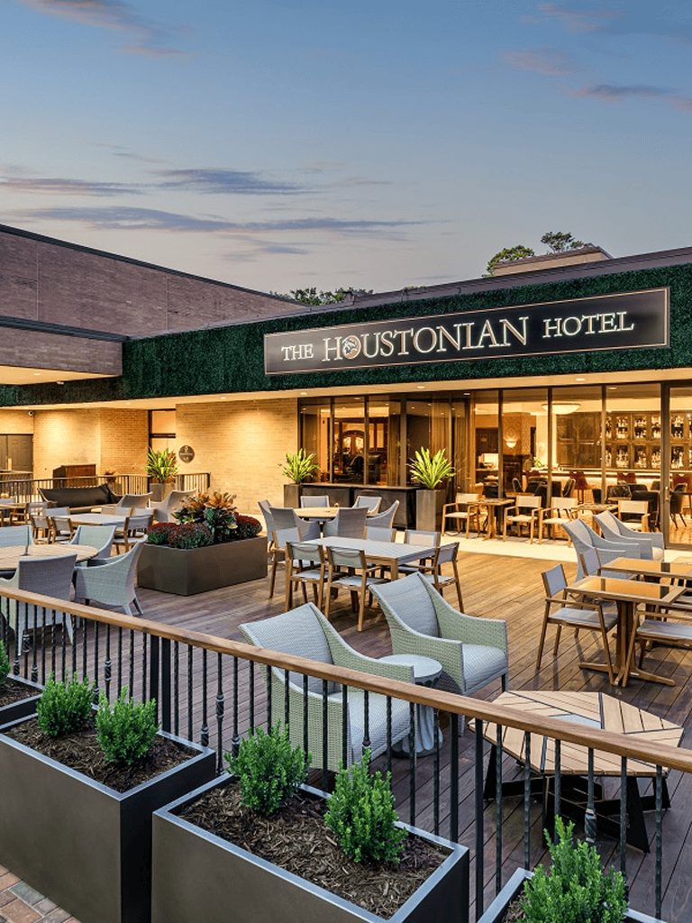 Outdoor patio at The Houstonian Hotel with seating and greenery.