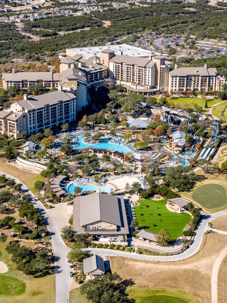 Luxurious resort with pools, water slides, and scenic grounds in a popular vacation destination.