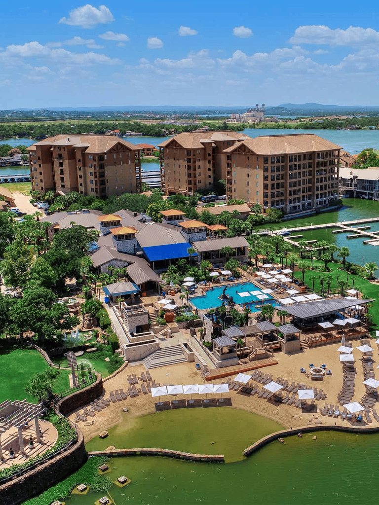 Luxury waterfront resort with pools and lush gardens in Texas, ideal for vacation and relaxation.
